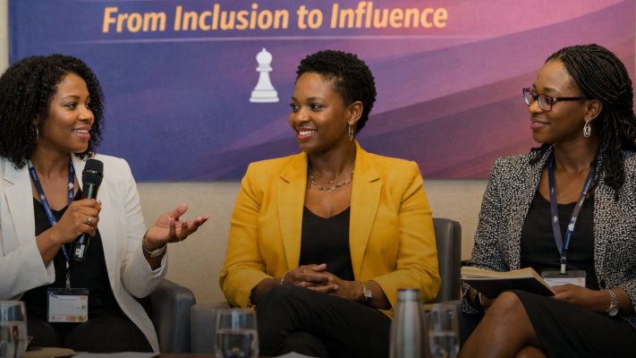 Three women participating in a panel discussion on inclusion and influence