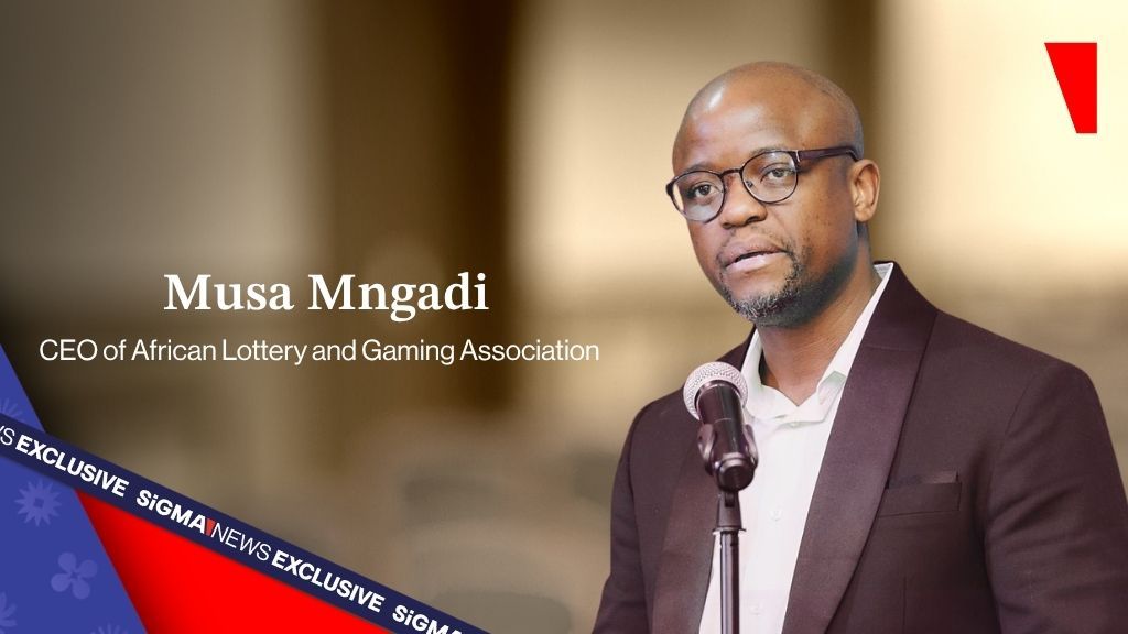 Musa Mngadi speaking at a microphone, featured by SiGMA News